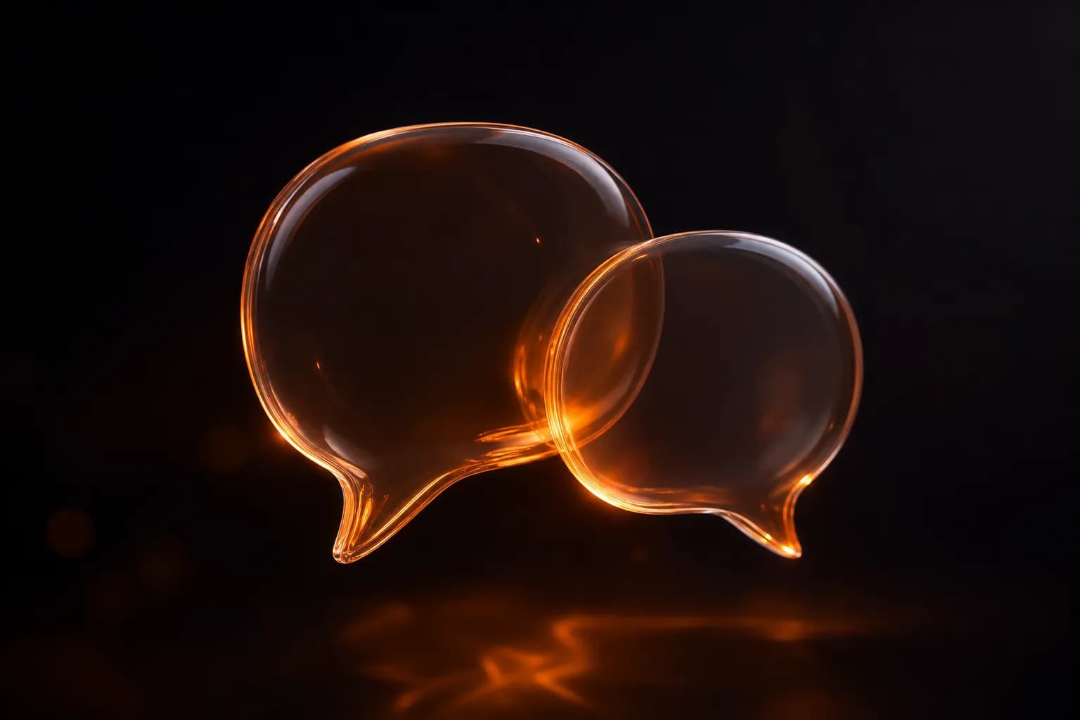 Two translucent glass chat bubbles glowing with warm amber light
